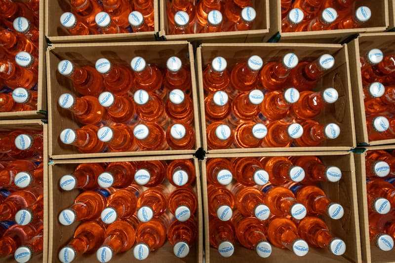Top-down photo of cased glass bottles filled with product Top-down photo of cased glass bottles filled with product
