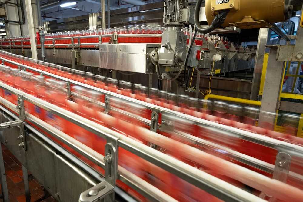 Photo of fast-moving bottles on a packaging line Photo of fast-moving bottles on a packaging line