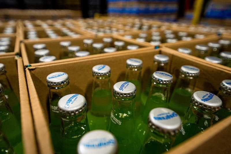 Close up photo of cased glass bottles filled with product Close up photo of cased glass bottles filled with product